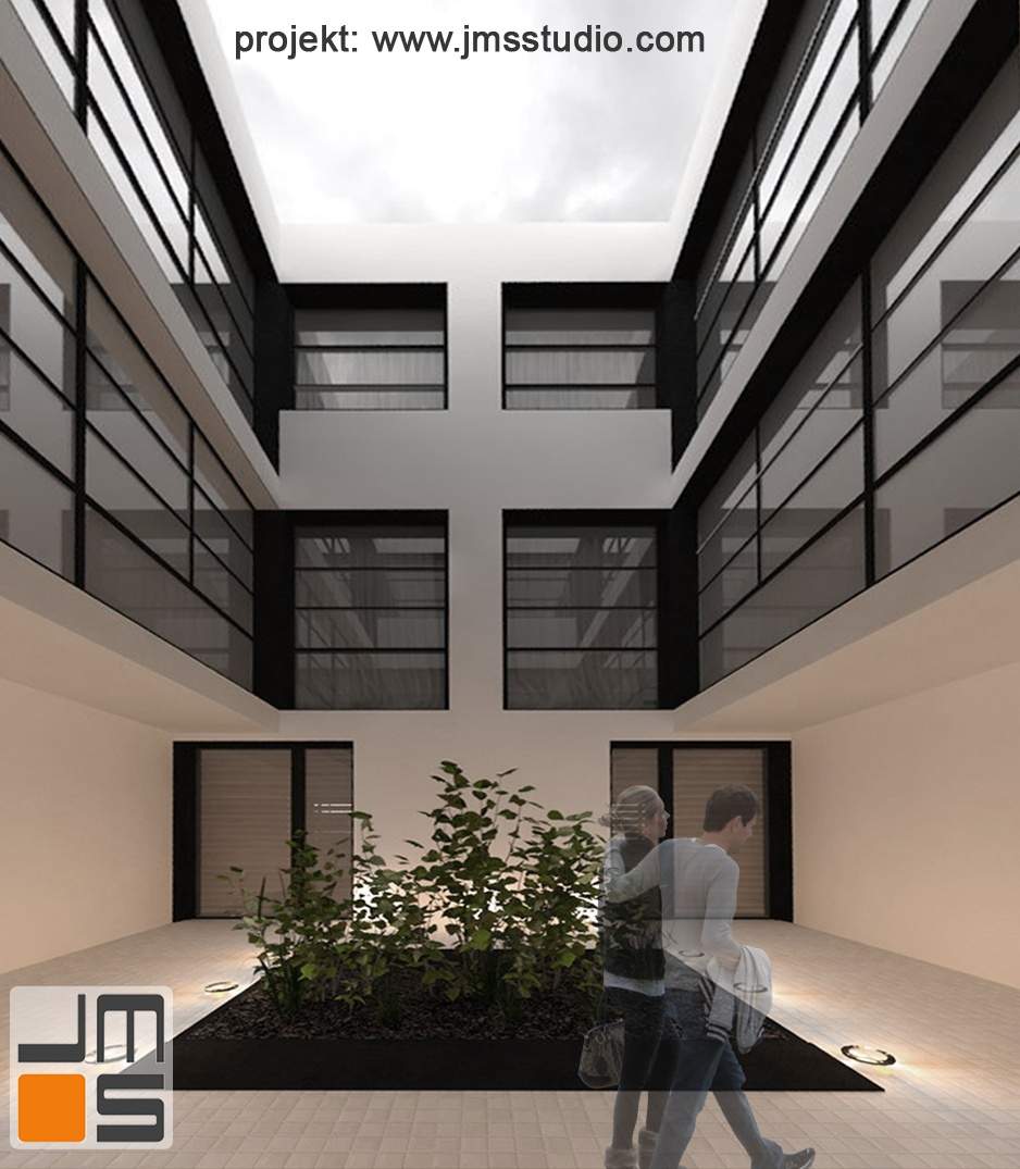 Architekt zaprojektował nowoczesny budynek w jasnej kolorystycze z odcieniami beżu i czarnymi antracytowymi dodatkami i elementami wykończeniowymi