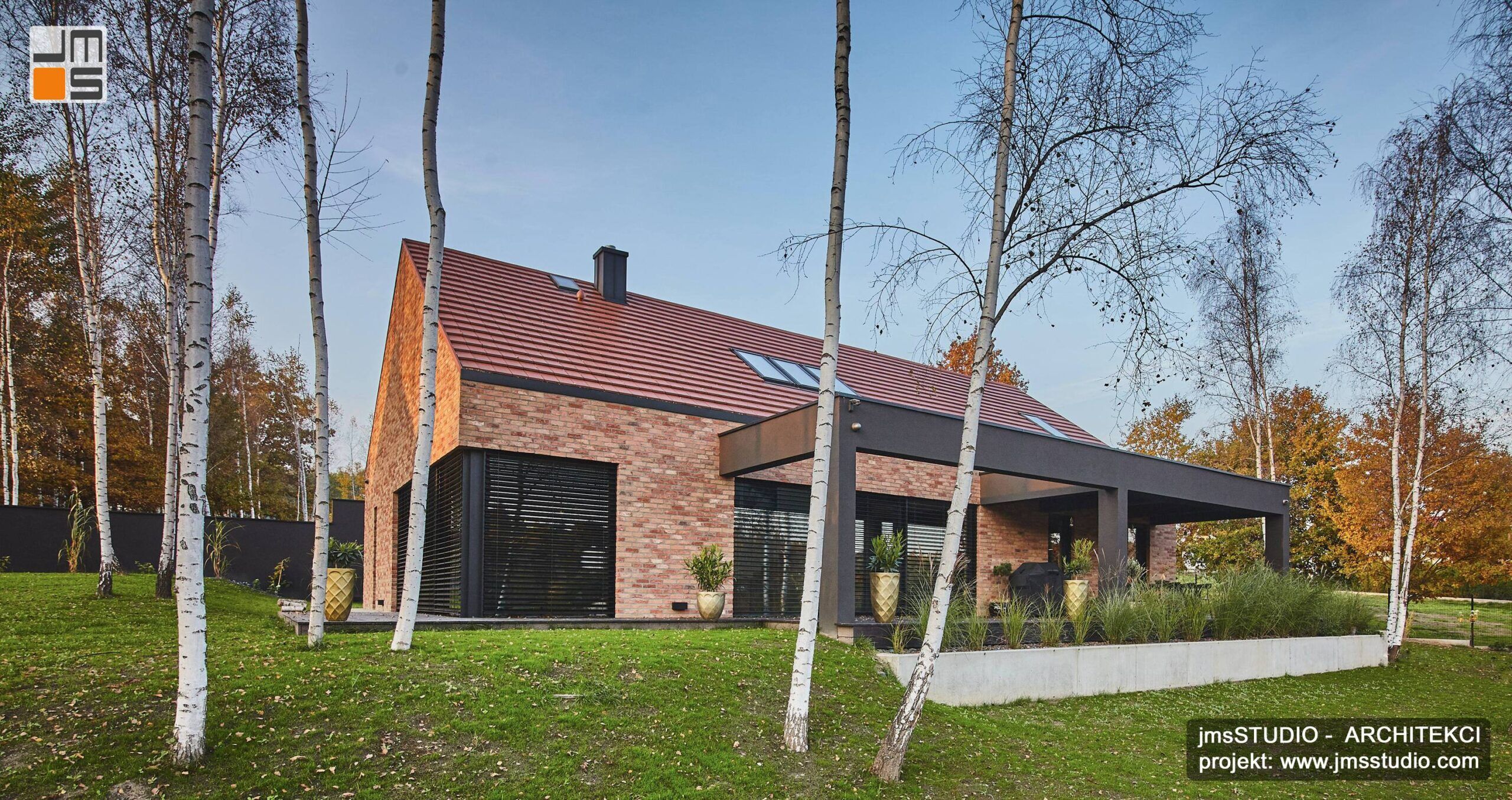 Piękny projekt domu z cegły z dekoracyjną ramą w kolorze antracytowym